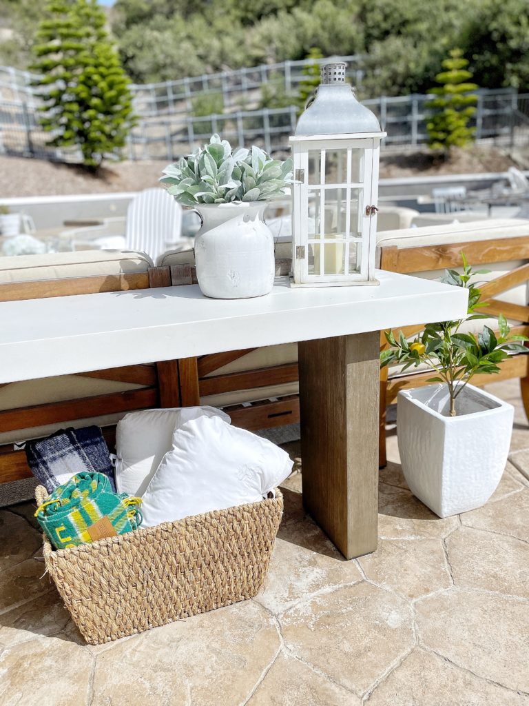 outdoor oasis with basket of blankets for backyard use on pottery barn outdoor console table with lanterns