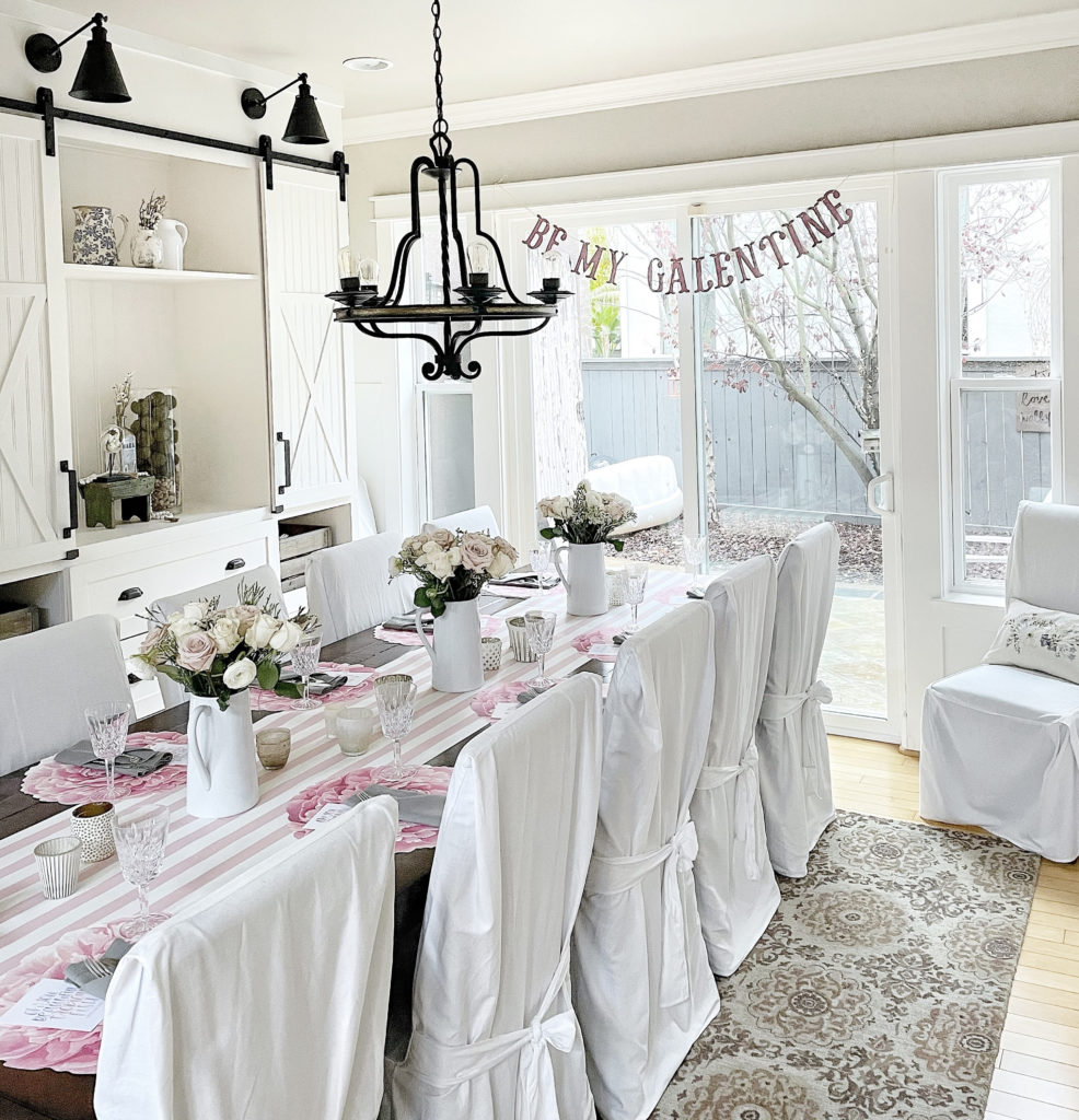 start a book club galentines day dining room table tablescape with blush roses and board and batten and sherwin williams accessible beige