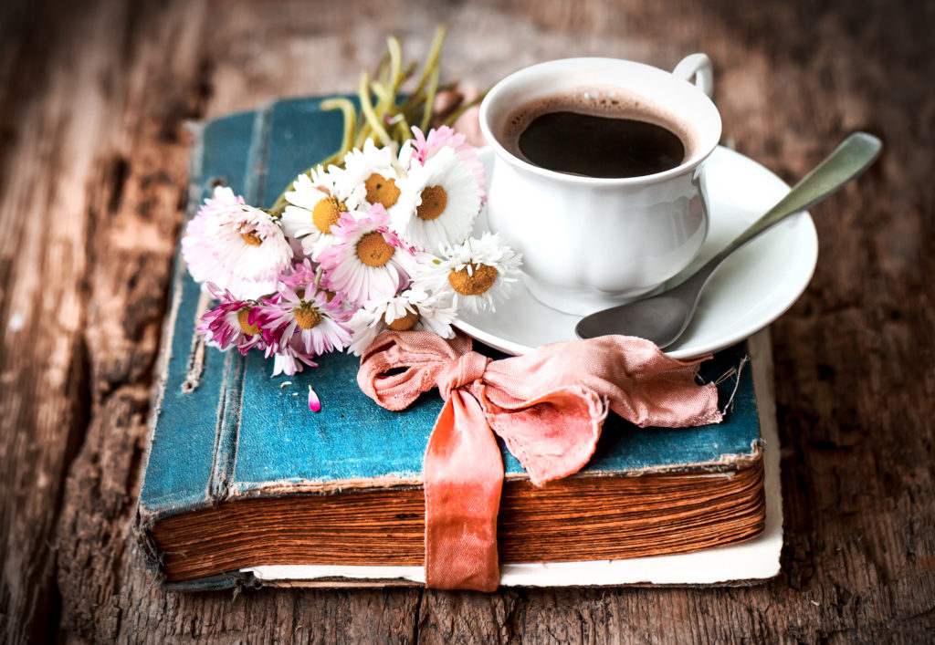 how to start a book club blue book with coffee cup and white daisies