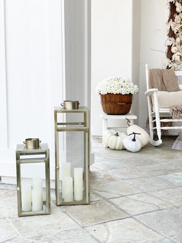 A welcoming fall porch with tips on how to make your front porch cozy and inviting using fall pillows, garlands, throws, and signs. House color is Sherwin WIlliams Pure White and Sherwin Williams Gauntlet Gray