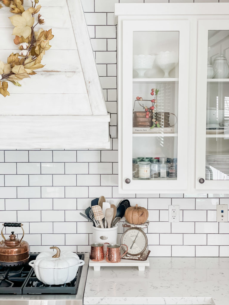 How to add simple fall decor to the kitchen. Includes neutral fall decor ideas. Walls are painted Sherwin Williams accessible beige. Photos have quartz countertops and and soapstone countertops with white subway tile backsplash. .