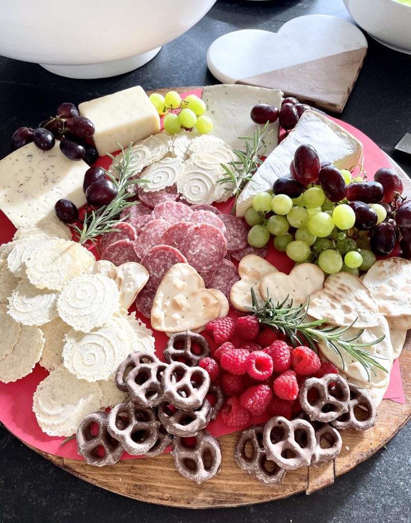 Ideas for a Galentine's Day Celebration including a favorite things theme for a gift exchange.  Tips include a Galentine's Day menu with waffles and a charcuterie board, decorations, and serving dishes.

#galentinesdayideas #valentinesdayparty #partyhosting #galentinesdayparty