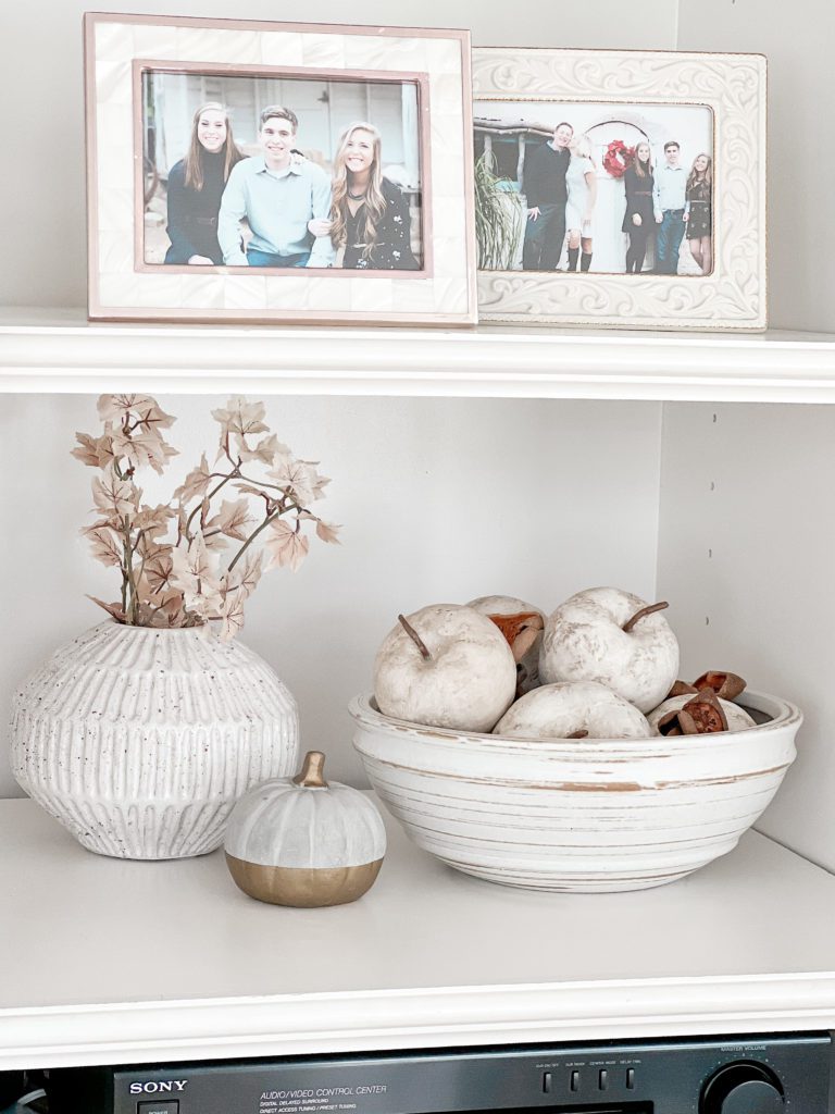 Four fun ideas for how to decorate for fall media center decor with a bowl of paper mache apples and a ceramic pumpkin and vase with leaves