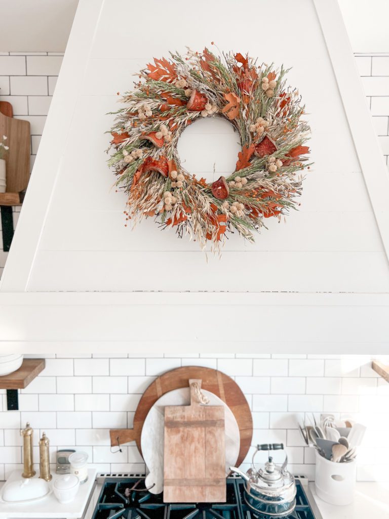 Simple Fall decorating ideas to get excited about with a fall wreath on a stovetop hood