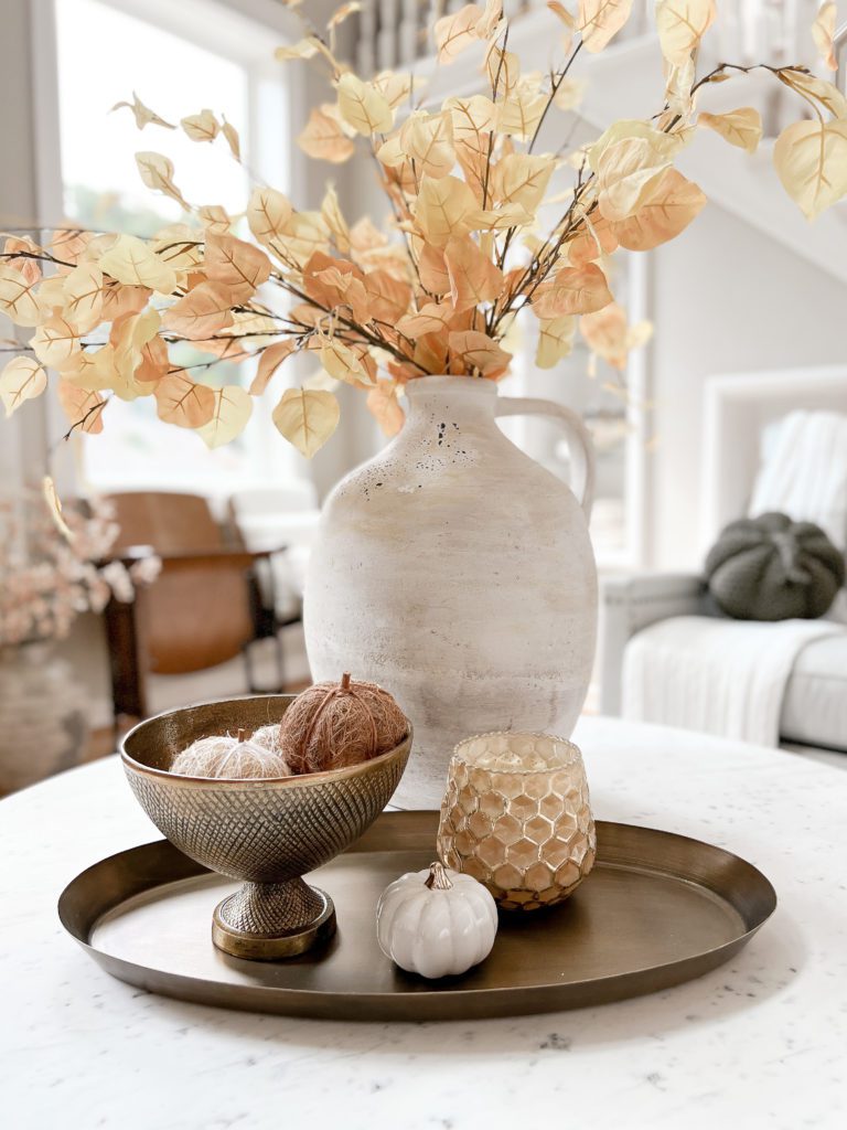 Four fun ideas for how to decorate for fall with a metal tray and candle and large jug vase with aspen leaves