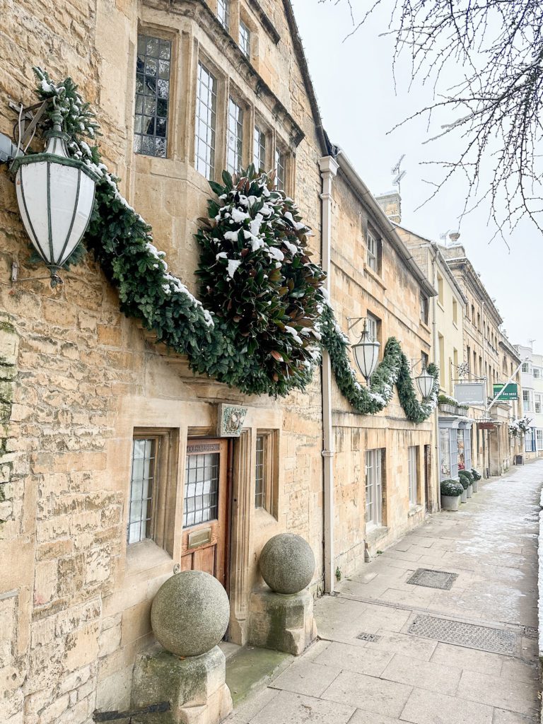 The Cotswolds winter travel guide | Winter in the Cotswolds | How to spend two days in the Cotswolds | Travel Guide to the Cotswolds without a car | Where to stay in the Cotswolds without a car | Where to eat in the Cotswolds | What villages in the Cotswolds to visit | Snow covered Cotswolds buildings | Winter in the Cotswolds | Visiting the Cotswolds | What to do in Chipping Campden | High Street in Chipping Campden