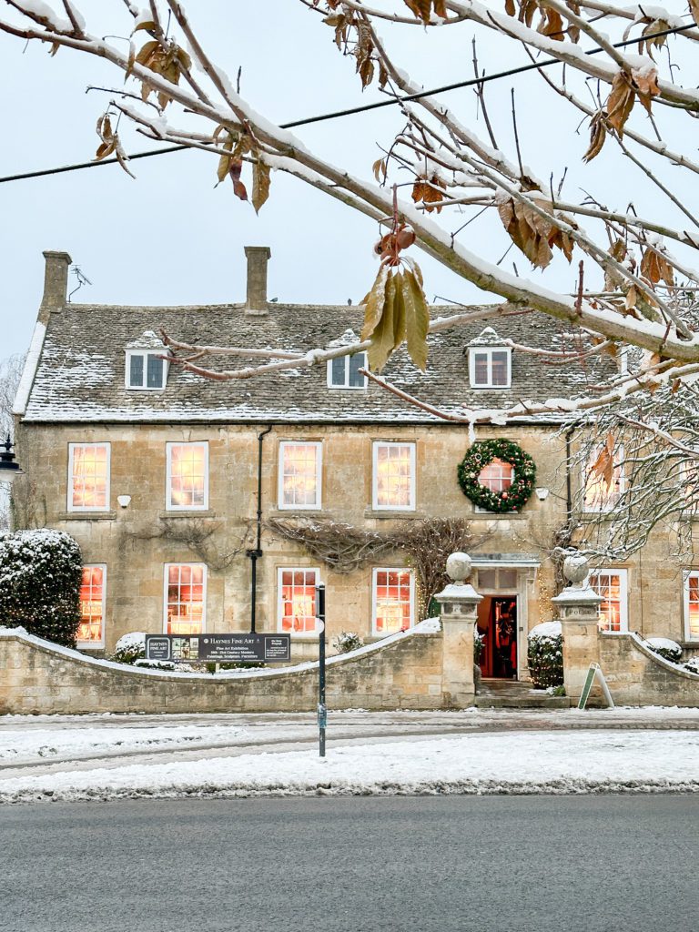The Cotswolds winter travel guide | Winter in the Cotswolds | How to spend two days in the Cotswolds | Travel Guide to the Cotswolds without a car | Where to stay in the Cotswolds without a car | Where to eat in the Cotswolds | What villages in the Cotswolds to visit | Snow covered Cotswolds buildings | Winter in the Cotswolds | Visiting the Cotswolds | Broadway in the Cotswolds | Haynes Fine Art in the Cotswolds