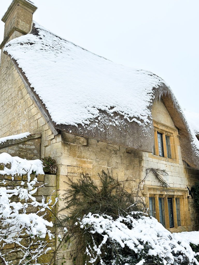The Cotswolds winter travel guide | Winter in the Cotswolds | How to spend two days in the Cotswolds | Travel Guide to the Cotswolds without a car | Where to stay in the Cotswolds without a car | Where to eat in the Cotswolds | What villages in the Cotswolds to visit | Snow covered Cotswolds buildings | Winter in the Cotswolds | Visiting the Cotswolds | What to do in Chipping Campden | Thatched roof in Cotswolds