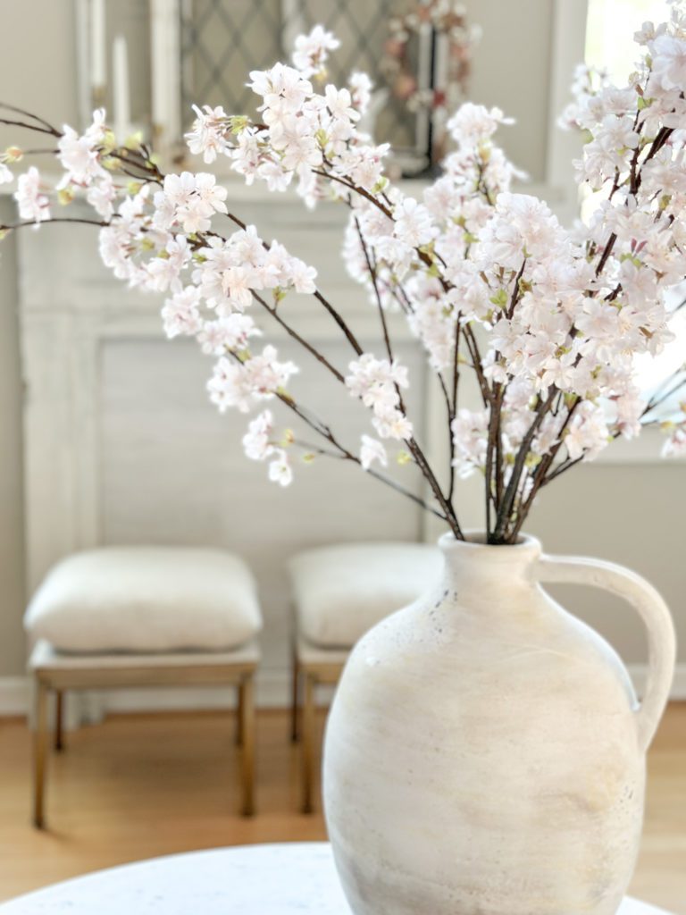 add simple spring touches to your entryway and living spaces | Using tulips and bunnies in your spring home | The best faux tulips | Where to use faux cherry blossoms | Where to put ceramic bunnies for spring decor | Sherwin Williams Accessible Beige | German schmeared brick floors | Family room spring decor ideas | Entryway spring decor | Easter home tour | How to decorate for spring 