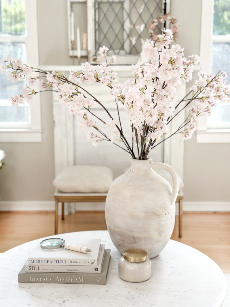 Add simple spring touches to your entryway and living spaces | Using tulips and bunnies in your spring home | The best faux tulips | Where to use faux cherry blossoms | Where to put ceramic bunnies for spring decor | Sherwin Williams Accessible Beige | German schmeared brick floors | Family room spring decor ideas | Entryway spring decor | Easter home tour | How to decorate for spring 
