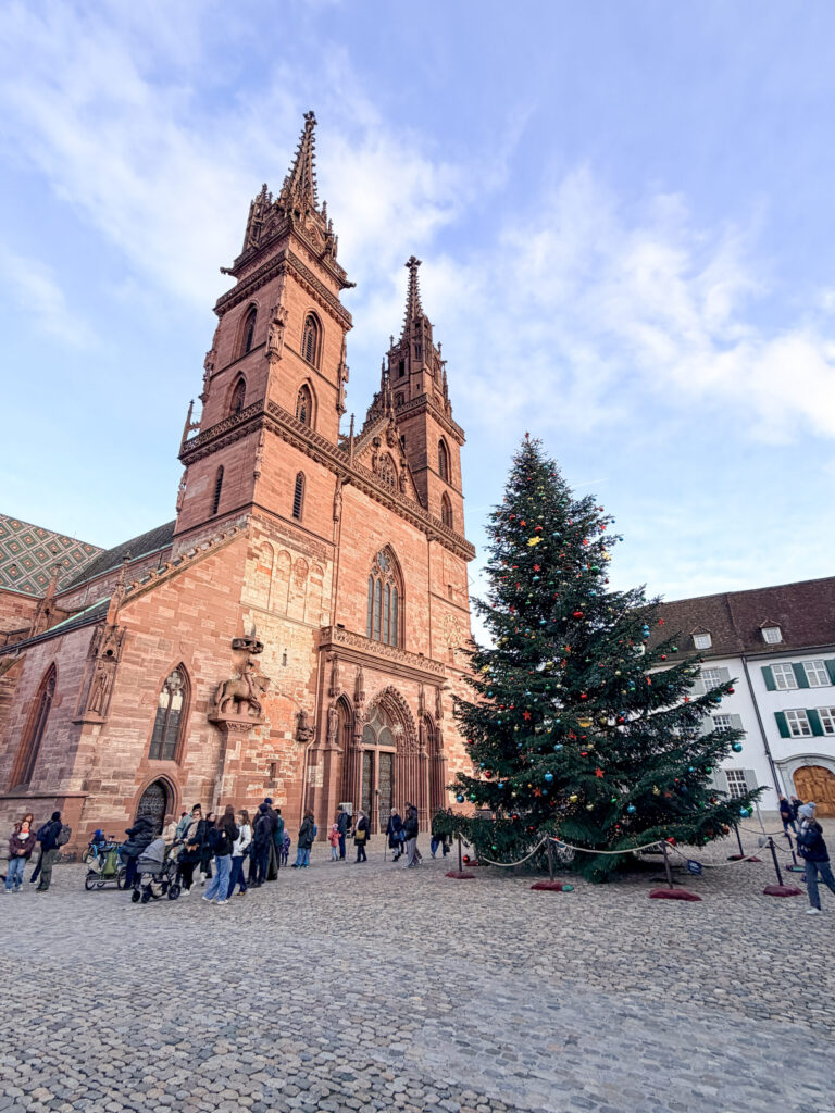 Basel Switzerland at Christmas TIme - A Complete Guide | Why I will always take a European Christmas Market trip every year | Top European Christmas Market to avoid massive crowds | Best Christmas Markets in Switzerland | Reasons to book a Flytographer photo shoot in Europe at Christmas time | Best five star hotels in Basel Switzerland | Top things to see and do in Basel at Christmas time | What to wear to the Basel Christmas market | How many days to spend in Basel for Christmas market trip | Where to find the Magical Christmas Courtyards in Basel | Visiting Basel Minster and what you need to know before climbing the tower 
